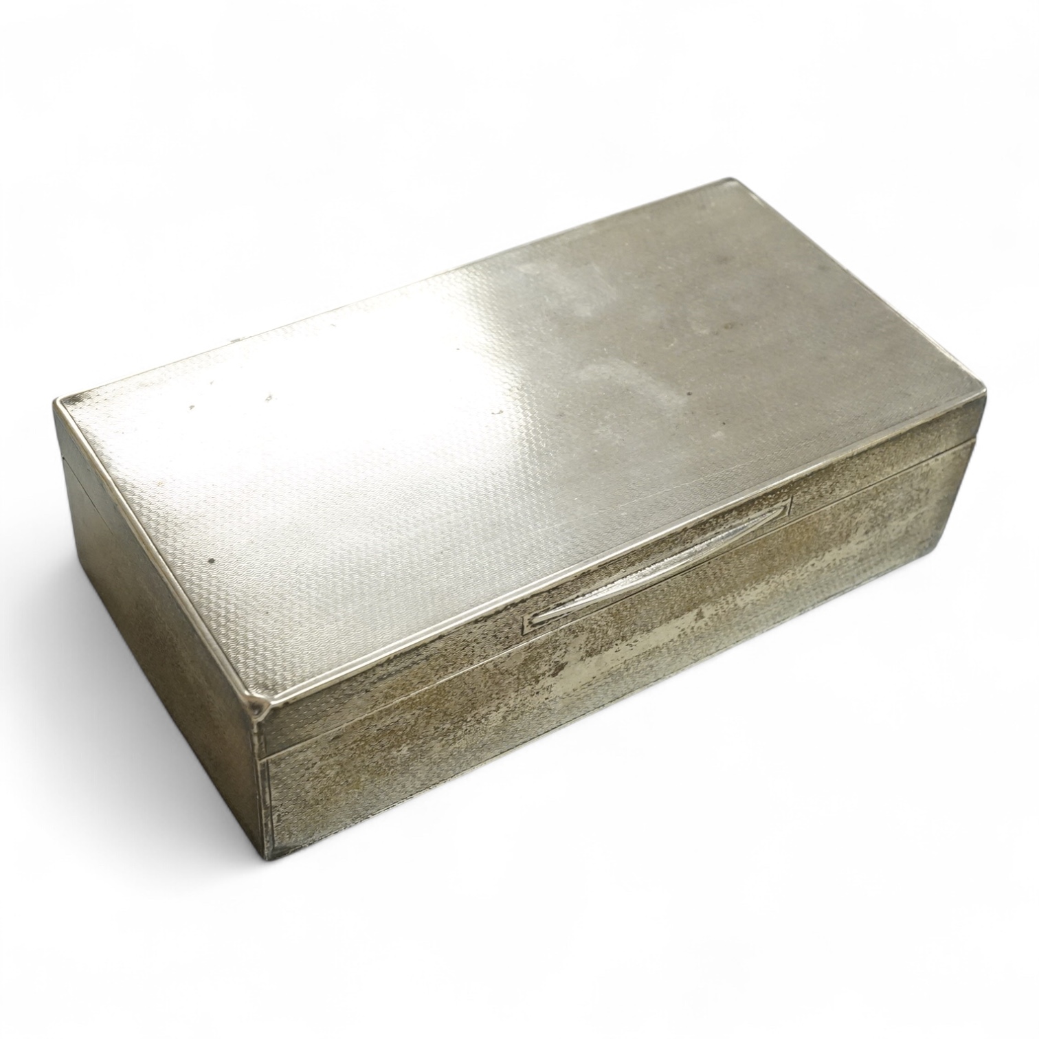 A George V engine turned silver mounted rectangular cigarette box by Harrods Ltd, London, 1932, 17.7cm.